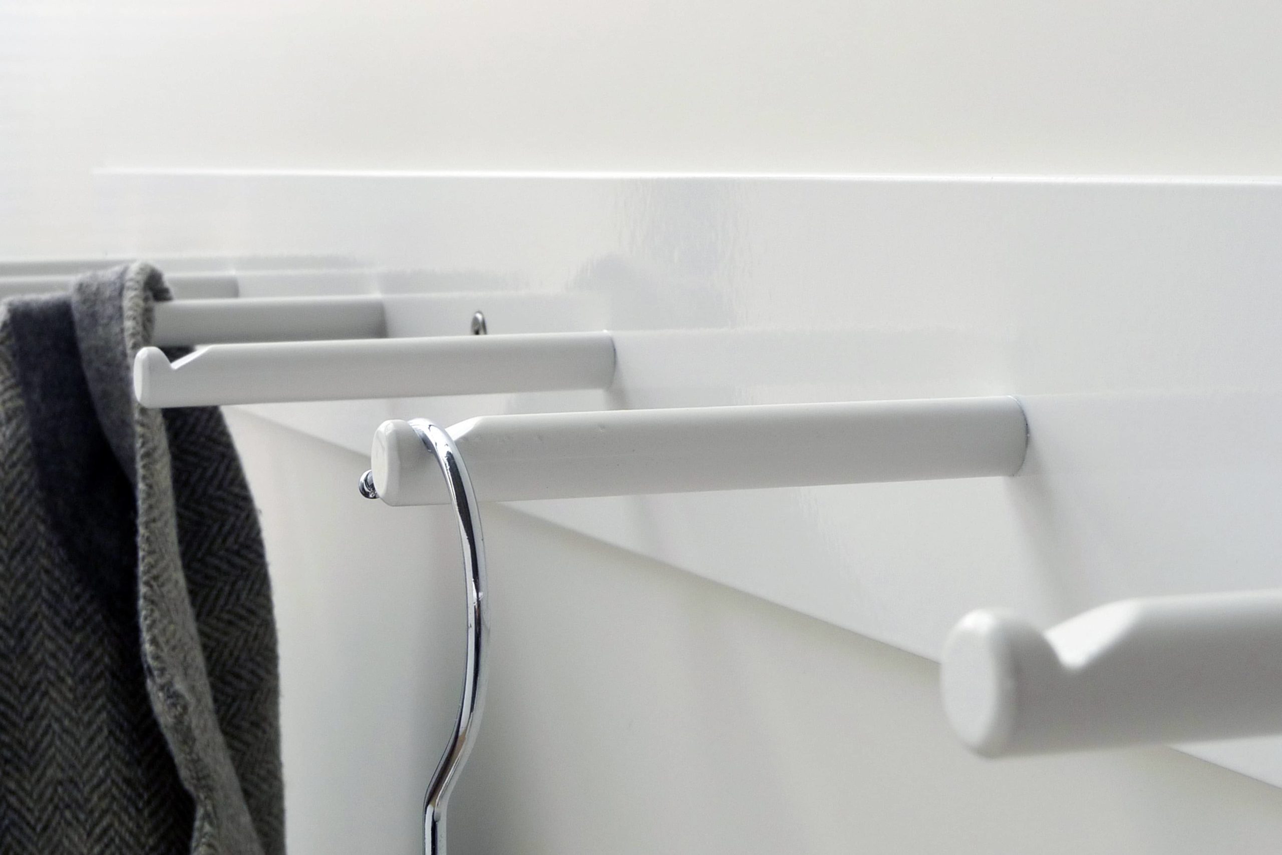 Hellogoodbye coat rack is made of a flat piece of steel white powder coated plus six round hooks with notches to prevent clothes or coat hangers from sliding off.